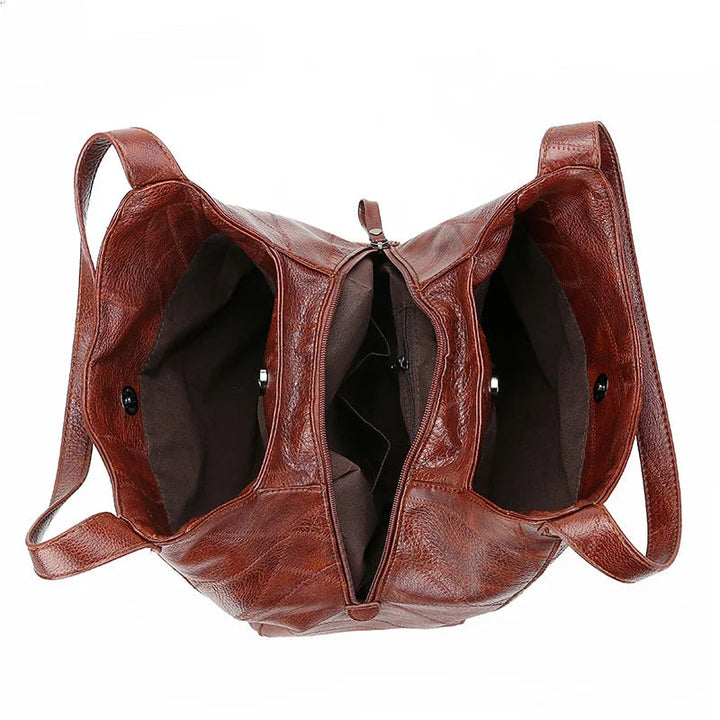 Here are a few options:

- Emilia – bolso de mano vintage
- Bolso de mano vintage Emilia
- Emilia: bolso vintage de mano
- Emilia, cartera de mano vintage
- Bolso vintage de mano “Emilia”