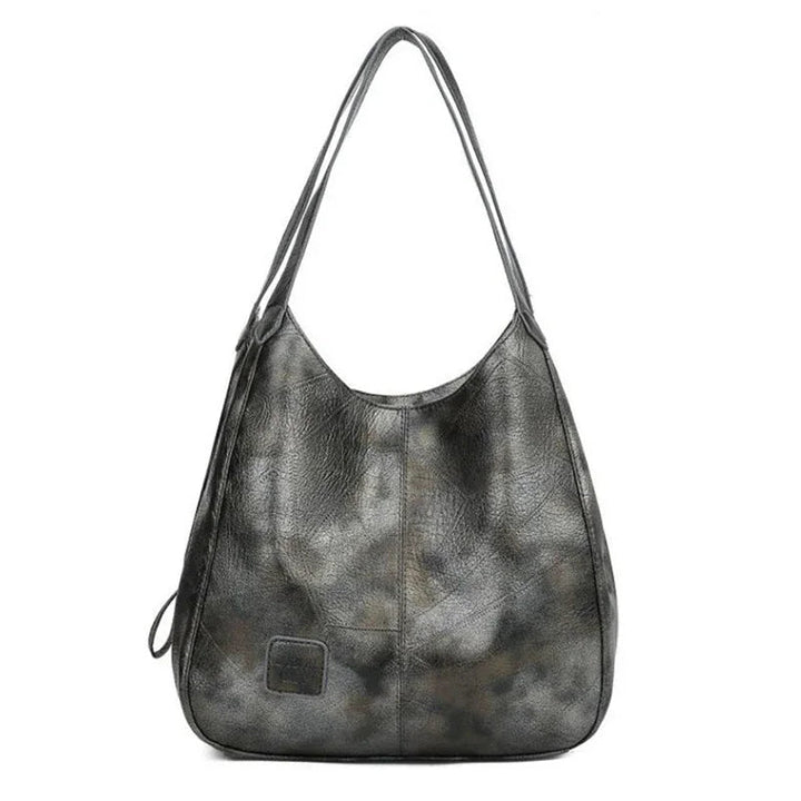 Here are a few options:

- Emilia – bolso de mano vintage
- Bolso de mano vintage Emilia
- Emilia: bolso vintage de mano
- Emilia, cartera de mano vintage
- Bolso vintage de mano “Emilia”